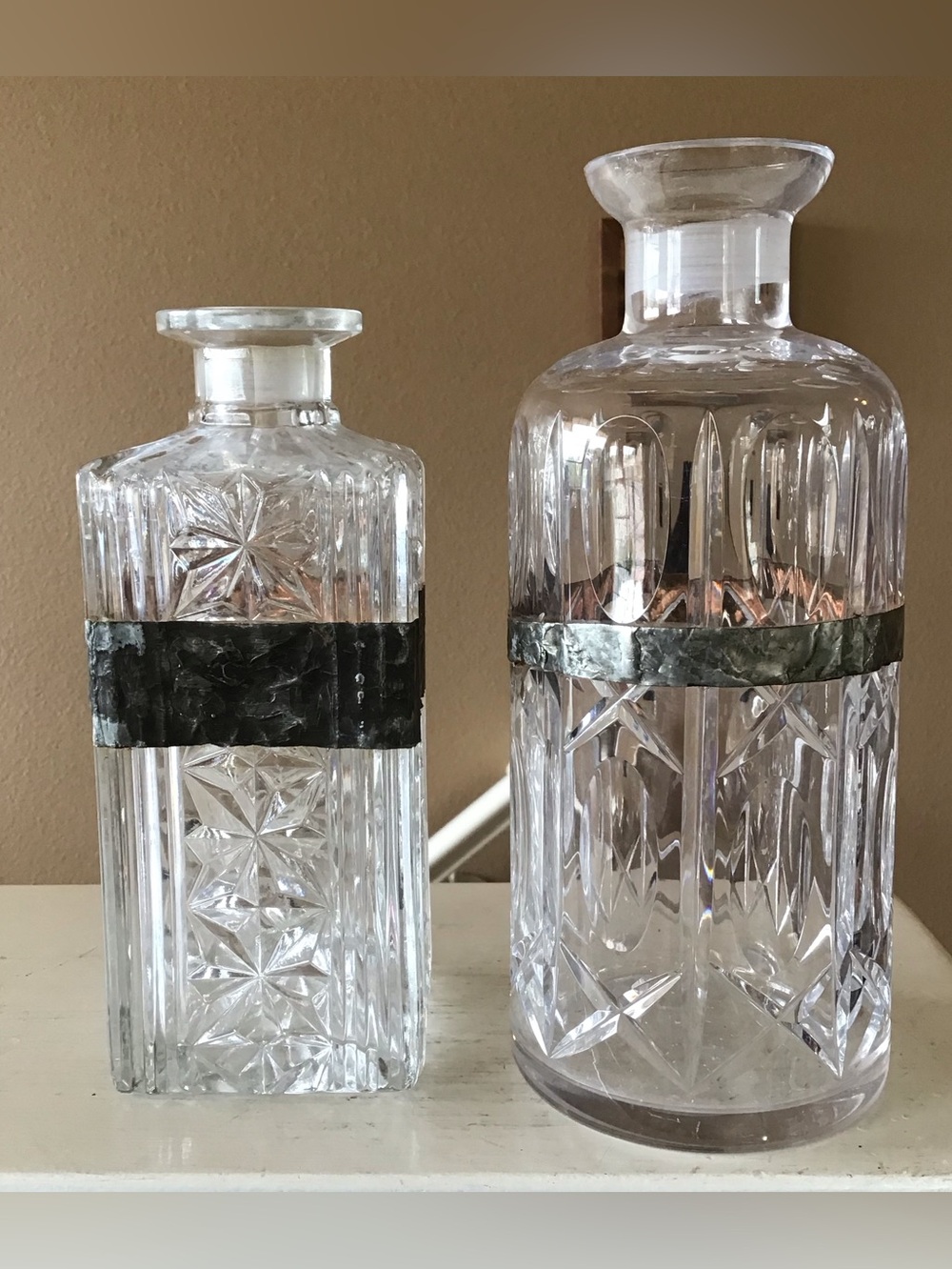 Set of Two Cut Glass Liquor Decanters with Rustic Metal Bands